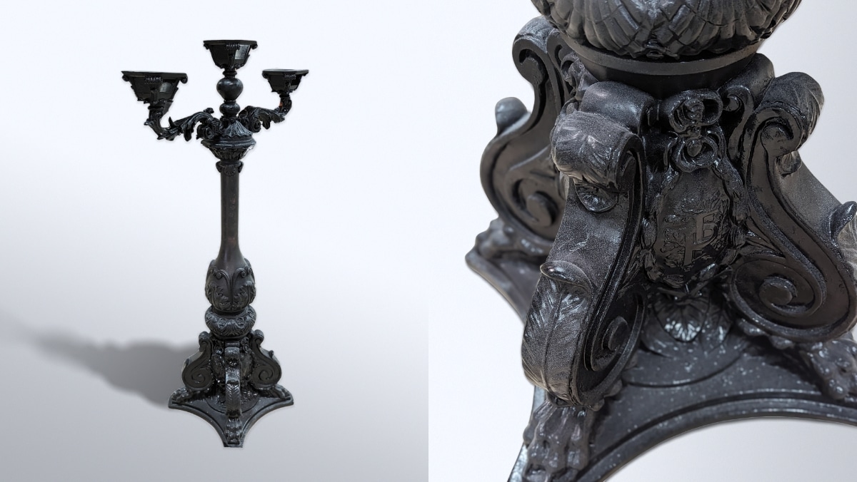 Fabrication - Dior Lamp Post 2 - 50_50 A dark ornate candelabrum with intricate patterns, featuring lion heads and a detailed base. Close-up view shows the elaborate design on the lower section, making it perfect for 3D scanning to capture every minute detail.