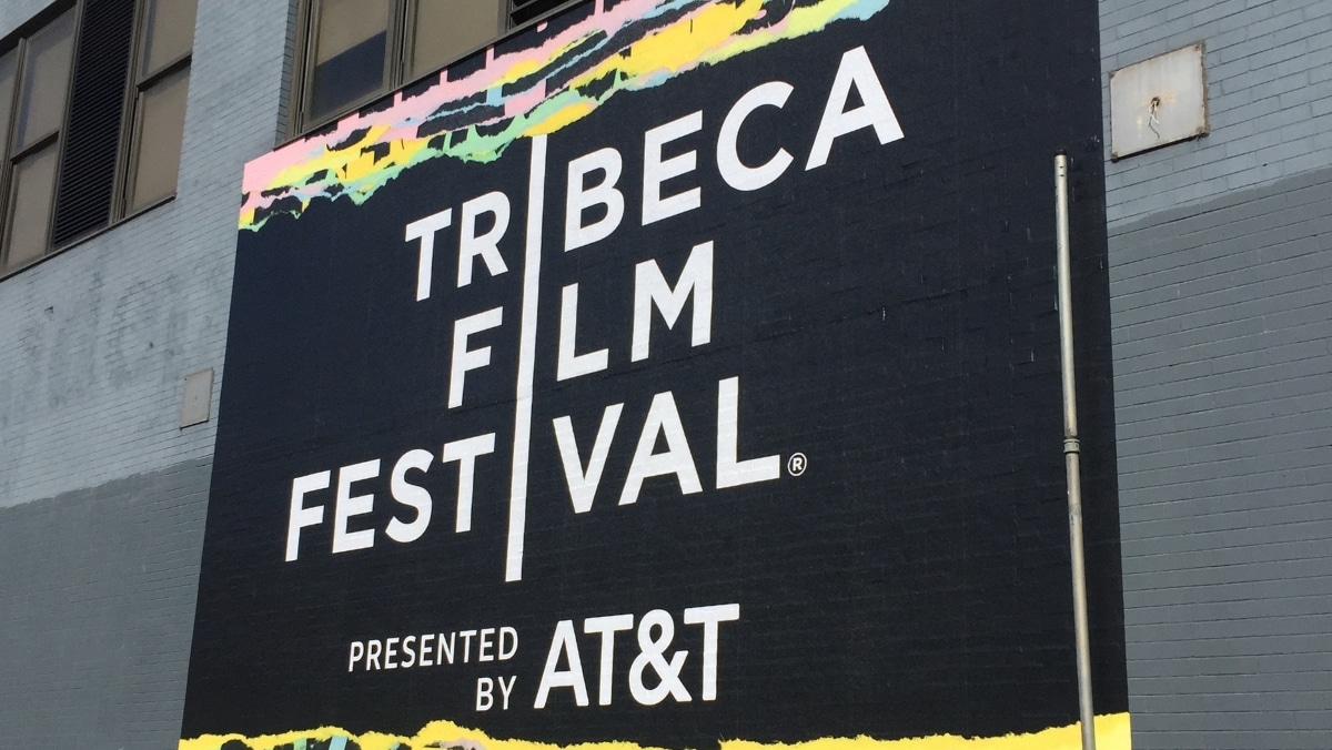 Large Format - Tribeca Film Festival - 50_50 A large mural on a brick wall advertising the Tribeca Film Festival, presented by AT&T, with a colorful paint border and incorporating elements of 3D scanning technology.